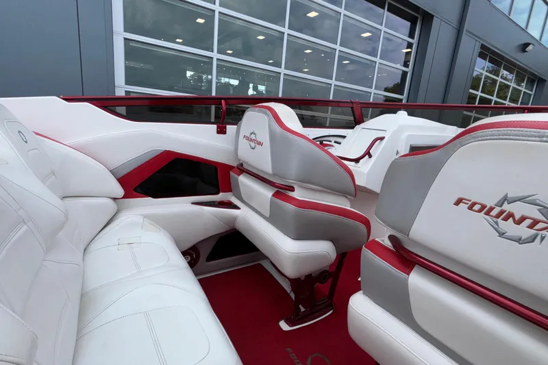 Slide: The Image of 2007 Fountain 38 Lightning boat interior with white and red seating, showcasing sleek design. - 17