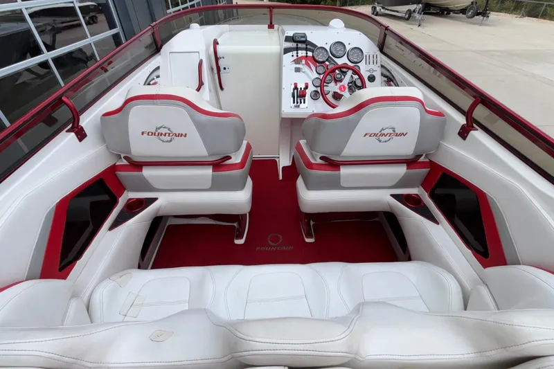 Slide: The Image of 2007 Fountain 38 Lightning boat interior with white and red seating, dashboard, and controls. - 18