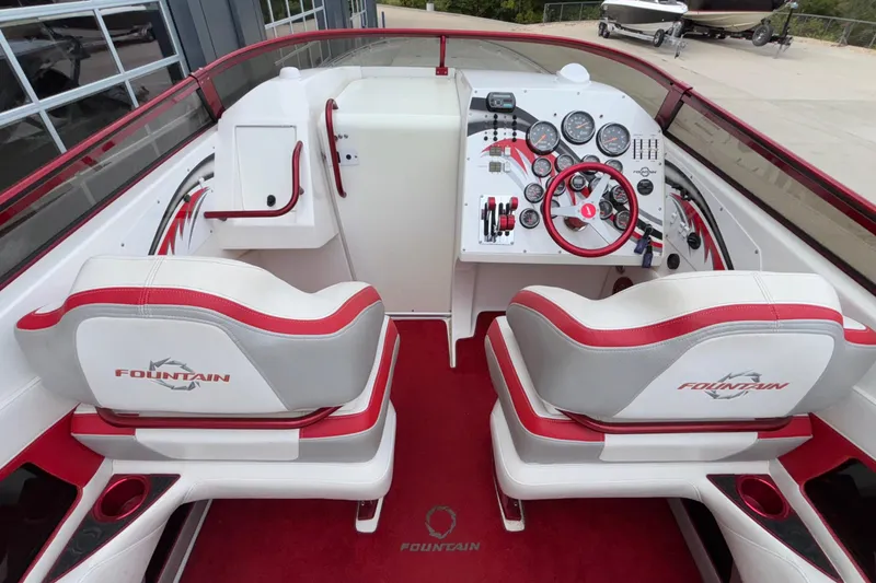 Slide: The Image of 2007 Fountain 38 Lightning boat cockpit with red and white interior, dual seats, and control panel. - 19