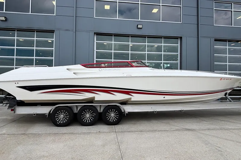 Slide: The Image of 2007 Fountain 38 Lightning speedboat on trailer, sleek design with red and black accents. - 2