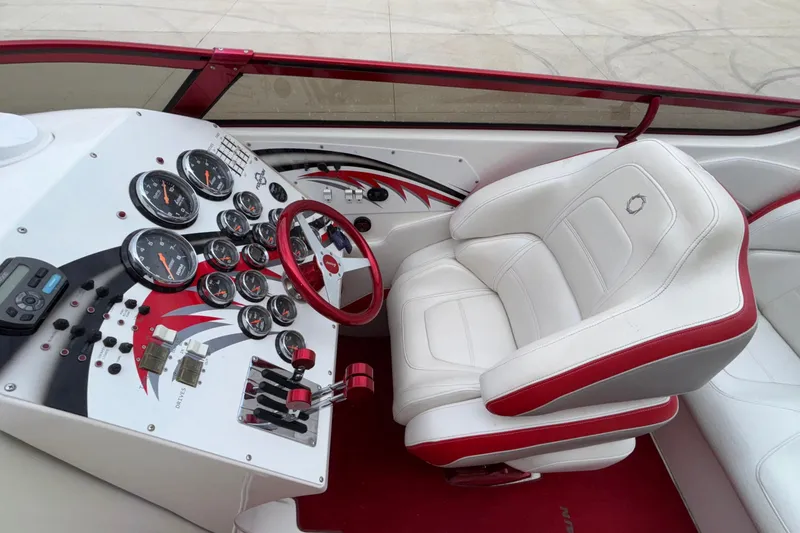 Slide: The Image of 2007 Fountain 38 Lightning boat cockpit with white and red seating, detailed dashboard controls. - 23