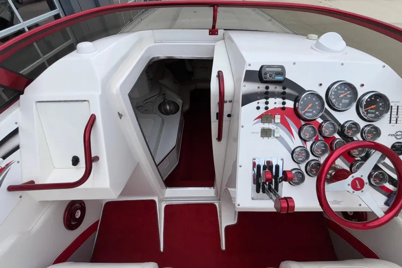 Slide: The Image of 2007 Fountain 38 Lightning boat cockpit with red accents and detailed instrument panel. - 26