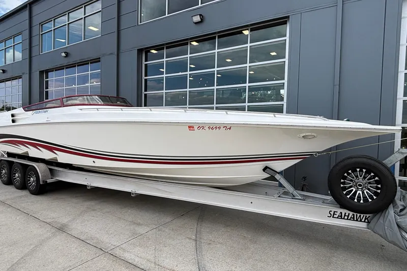 Slide: The Image of 2007 Fountain 38 Lightning boat on trailer outside modern building. - 3