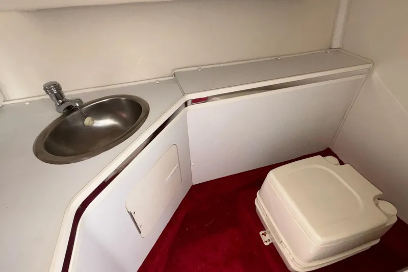 Slide: The Image of 2007 Fountain 38 Lightning boat interior with sink and portable toilet. - 32