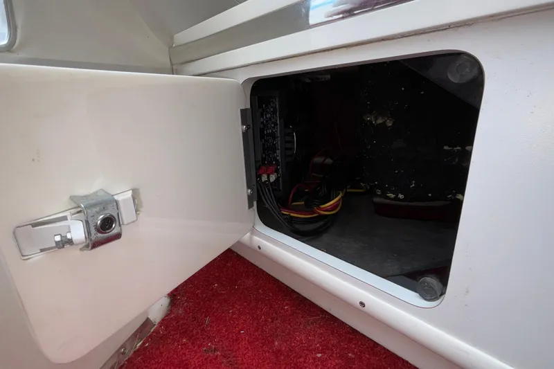 Slide: The Image of Open electrical compartment in 2007 Fountain 38 Lightning boat with red carpet interior. - 38