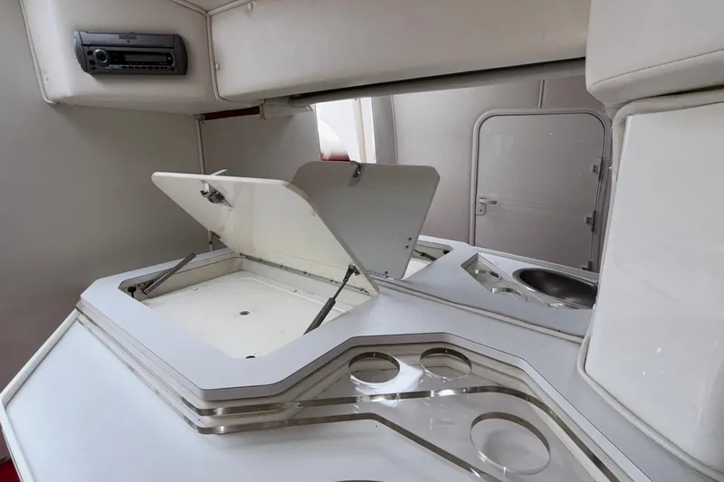 Slide: The Image of Interior of 2007 Fountain 38 Lightning boat with open storage compartments and sink. - 39