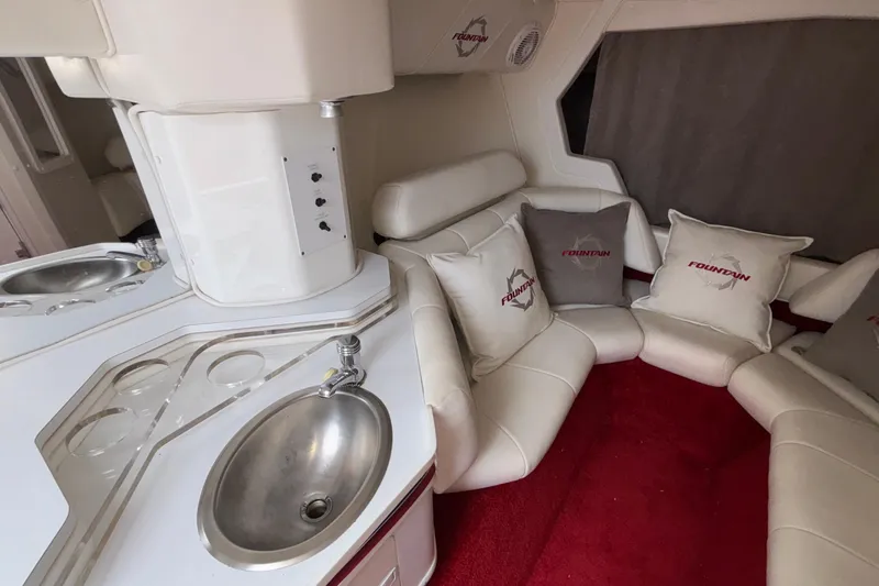 Slide: The Image of 2007 Fountain 38 Lightning interior with white seating, red carpet, and stainless steel sink. - 40