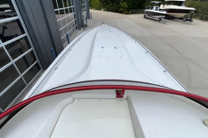 Slide: The Image of 2007 Fountain 38 Lightning boat on a concrete driveway near a garage. - 43