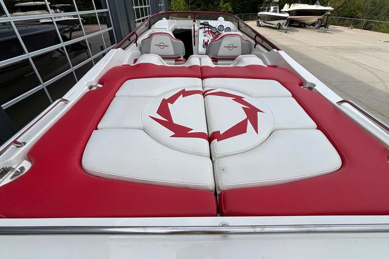Slide: The Image of 2007 Fountain 38 Lightning boat with red and white seating, docked outdoors. - 5