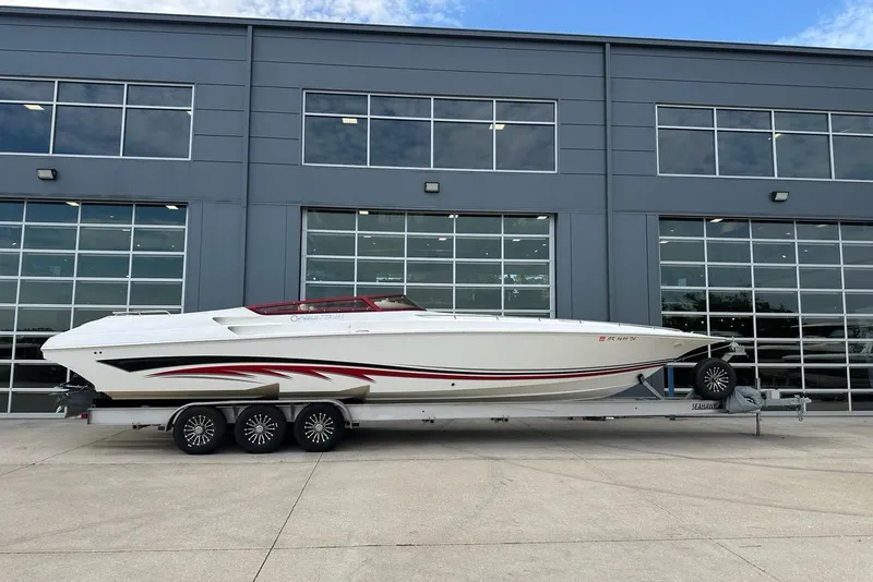 Slide: The Image of 2007 Fountain 38 Lightning boat on trailer, parked outside a modern building. - 50