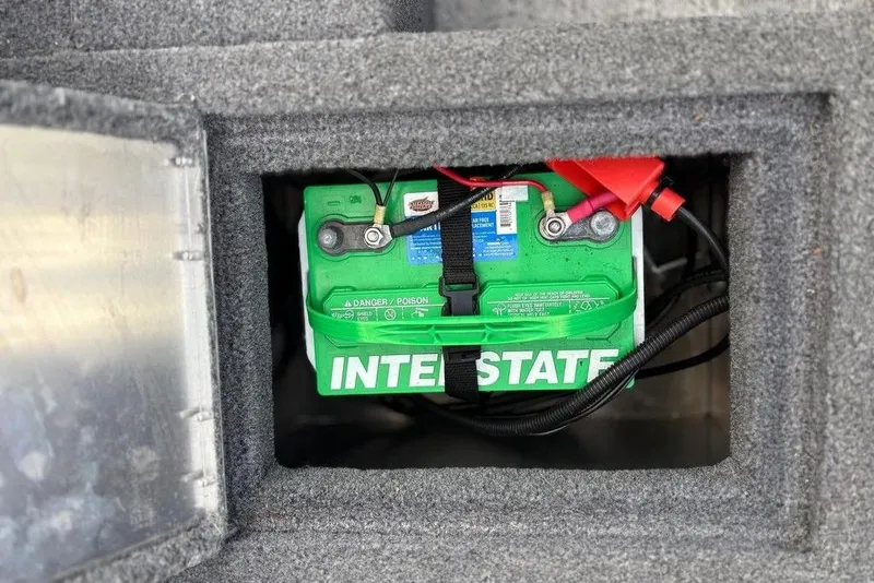 Slide: The Image of Battery compartment of 2023 Tracker Pro Guide V-16 SC boat, featuring Interstate battery. - 10