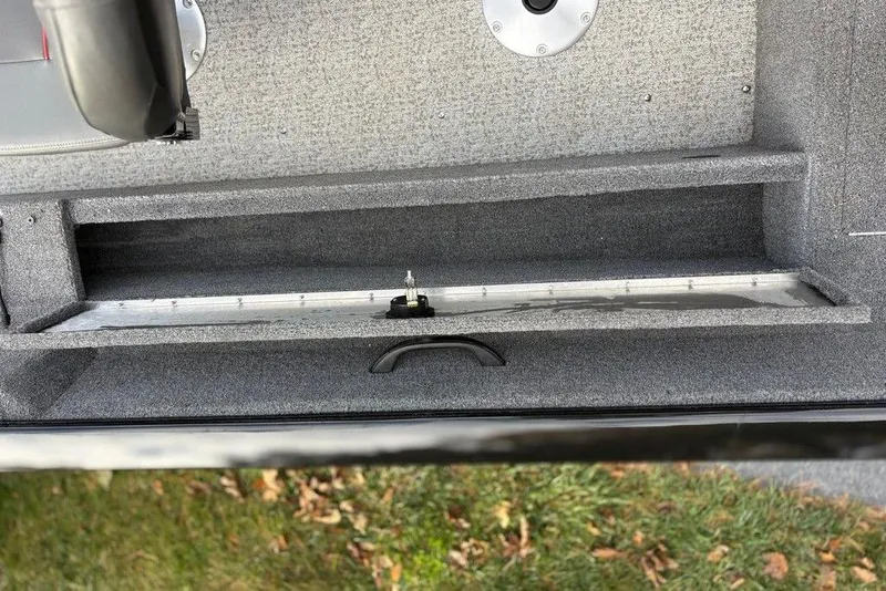 Slide: The Image of 2023 Tracker Pro Guide V-16 SC boat interior storage compartment, gray carpeted finish. - 14
