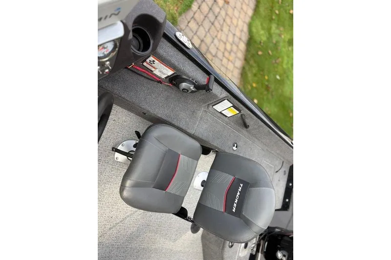 Slide: The Image of 2023 Tracker Pro Guide V-16 SC boat interior with seating and control panel. - 16