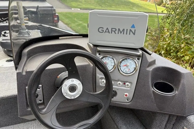 Slide: The Image of 2023 Tracker Pro Guide V-16 SC boat dashboard with Garmin GPS and steering wheel. - 3