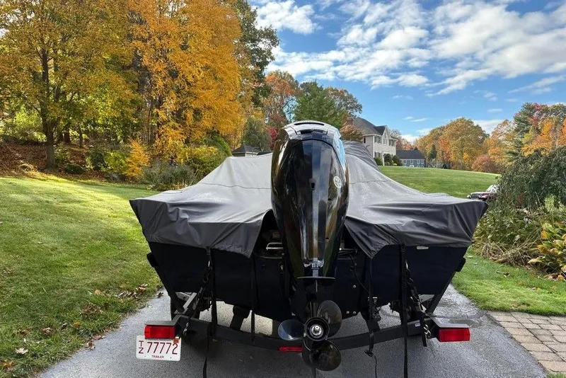 Slide: The Image of 2023 Tracker Pro Guide V-16 SC boat on trailer, covered, in scenic autumn setting. - 4