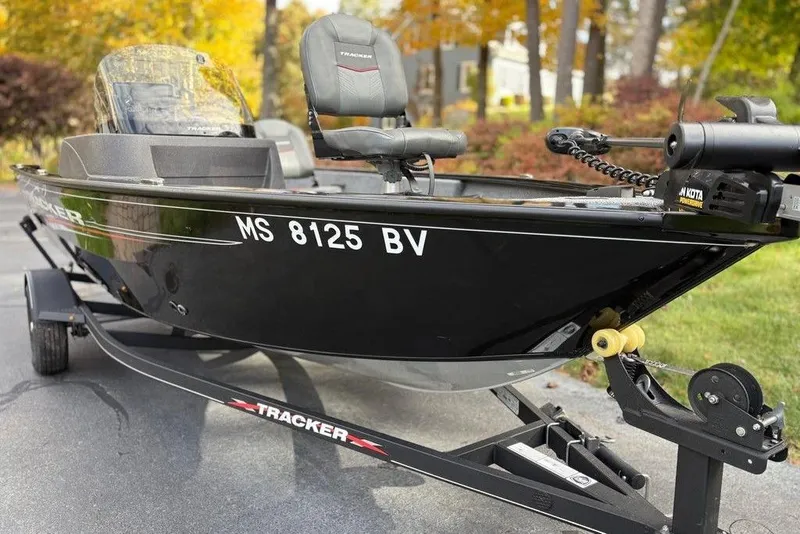 Slide: The Image of 2023 Tracker Pro Guide V-16 SC boat on trailer, parked outdoors in autumn setting. - 5