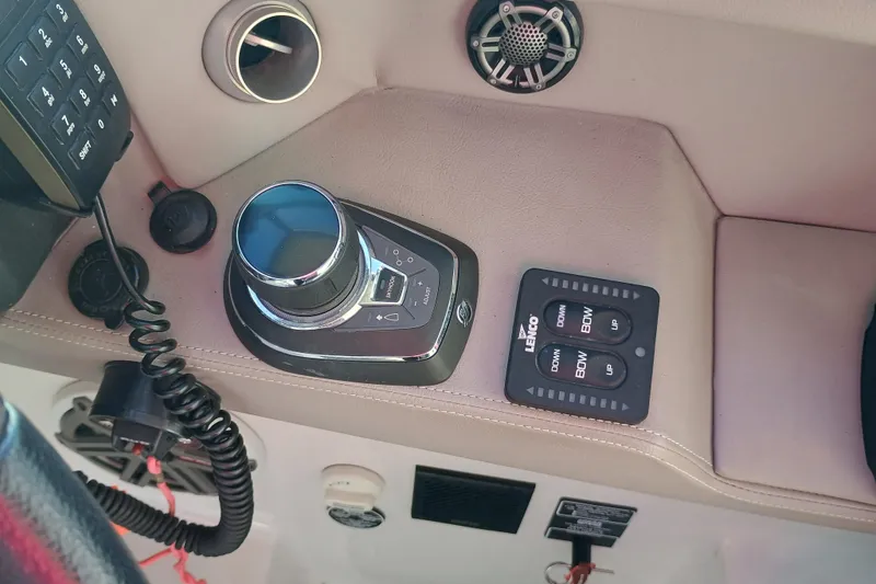 Slide: The Image of Control panel of a 2019 Four Winns H350 boat with joystick and trim tabs. - 12