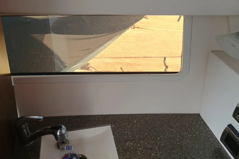 Slide: The Image of Interior view of 2019 Four Winns H350 boat, featuring a sink and window. - 17