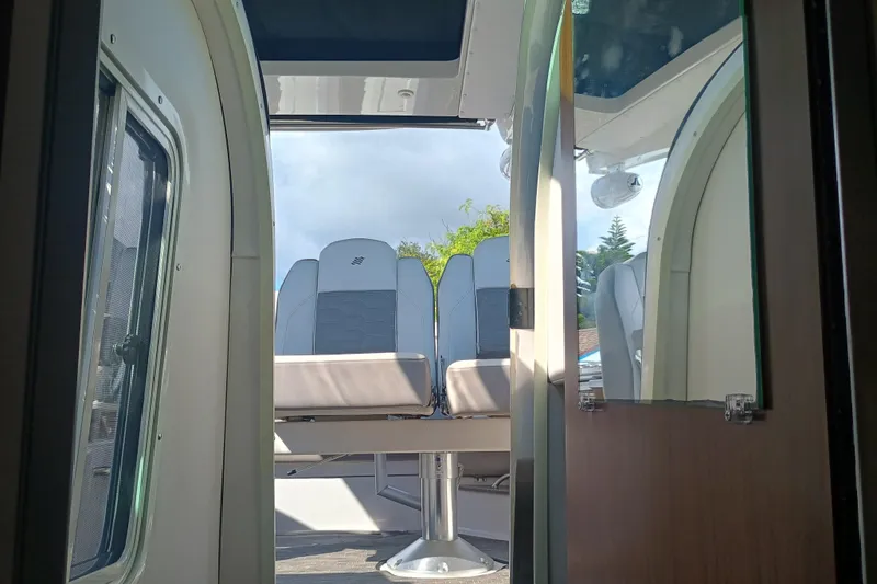 Slide: The Image of Interior view of 2019 Four Winns H350 boat, showcasing seating and cabin details. - 19