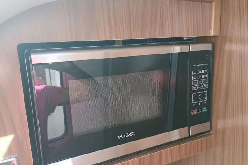 Slide: The Image of Built-in microwave in 2019 Four Winns H350 boat kitchen, wood paneling. - 20