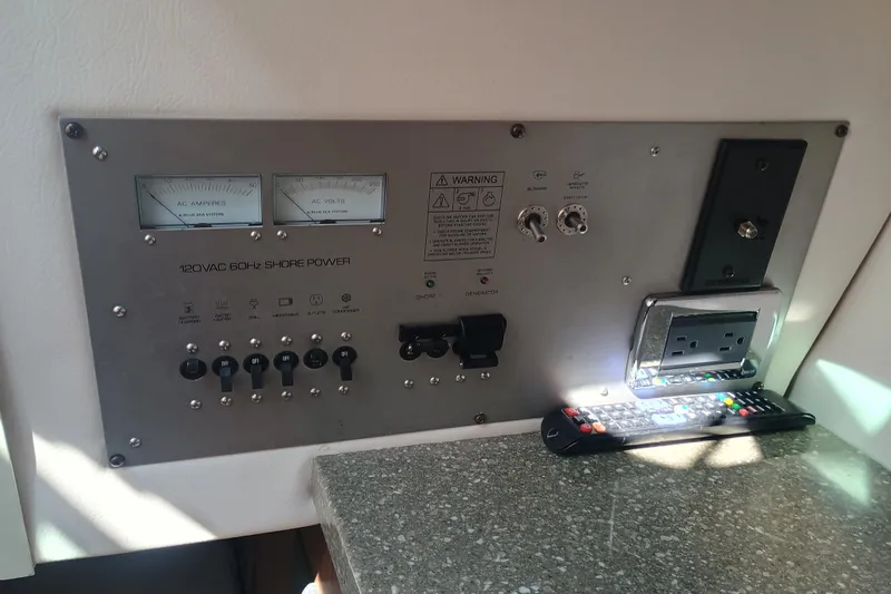 Slide: The Image of Control panel of 2019 Four Winns H350 boat with shore power and outlets. - 22