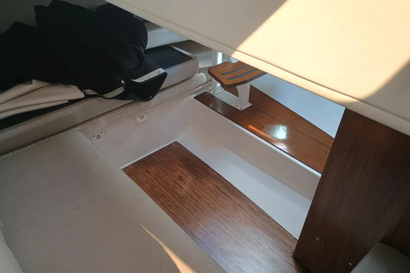 Slide: The Image of Interior of 2019 Four Winns H350 boat with wooden flooring and seating. - 26