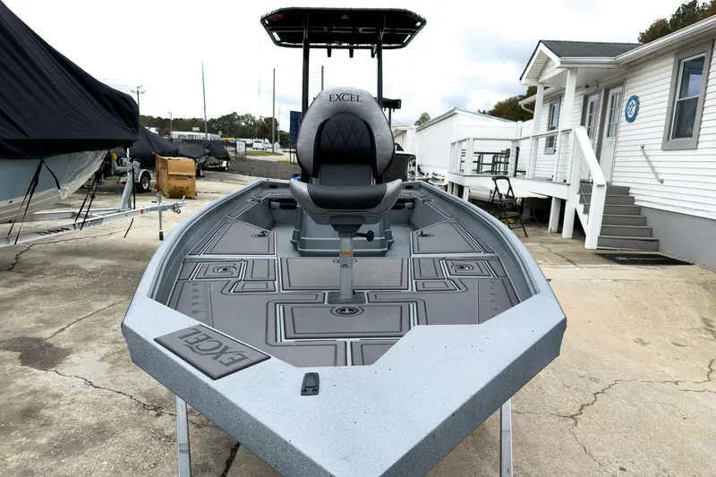 Slide: The Image of 2026 Excel Bay Pro Elite 230 boat on display at a marina. - 17