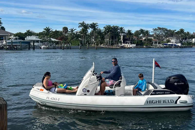 Slide: The Image of Family enjoying a ride on a 2023 Highfield Sport 560 boat in a scenic waterway. - 3