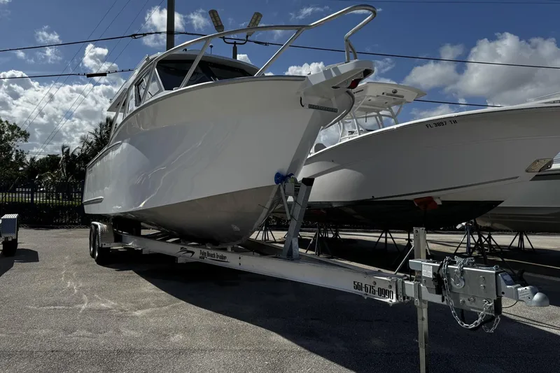Slide: The Image of 2024 GENESIS 2700 Cuddy boat on trailer under clear sky. - 28