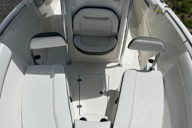 Slide: The Image of Interior view of 2021 Sailfish 242 CC boat, featuring cushioned seating and storage compartments. - 14