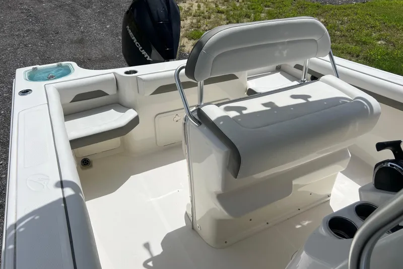 Slide: The Image of 2021 Sailfish 242 CC boat interior with seating and Mercury engine. - 15