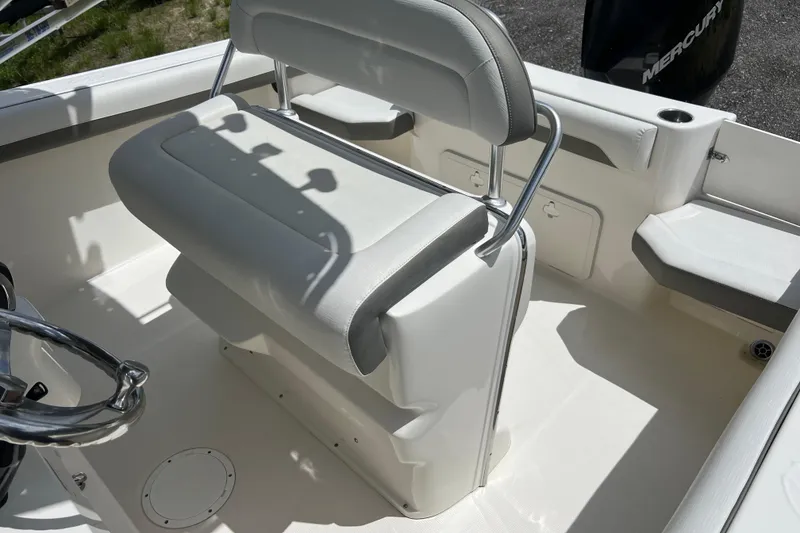 Slide: The Image of 2021 Sailfish 242 CC boat interior with seating and steering wheel. - 17