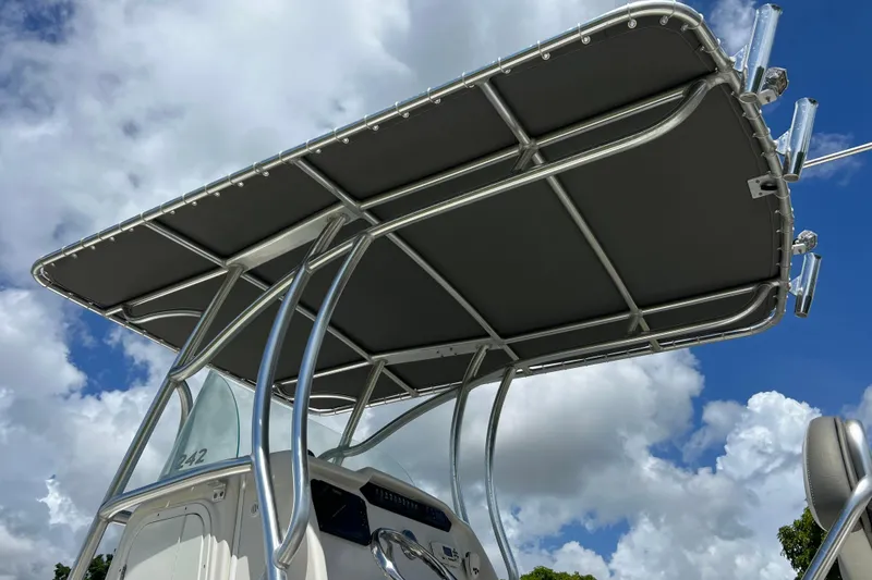 Slide: The Image of T-top of 2021 Sailfish 242 CC boat against a cloudy sky background. - 28