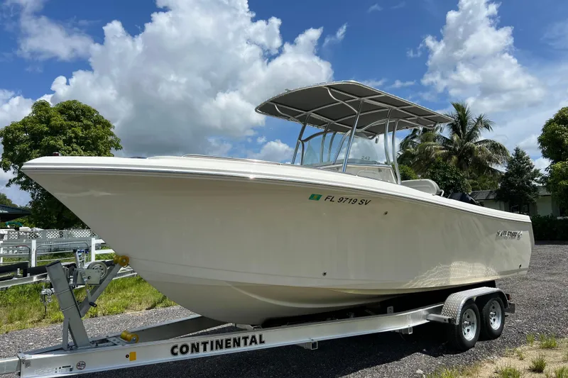 Slide: The Image of 2021 Sailfish 242 CC boat on trailer under blue sky with clouds. - 3