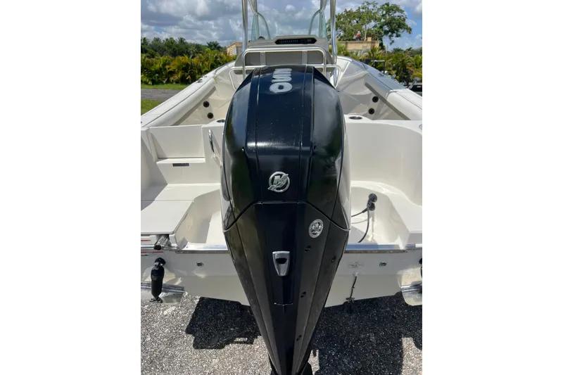 Slide: The Image of 2021 Sailfish 242 CC boat with powerful outboard motor, parked outdoors. - 33