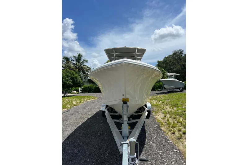 Slide: The Image of 2021 Sailfish 242 CC boat on trailer under blue sky. - 6