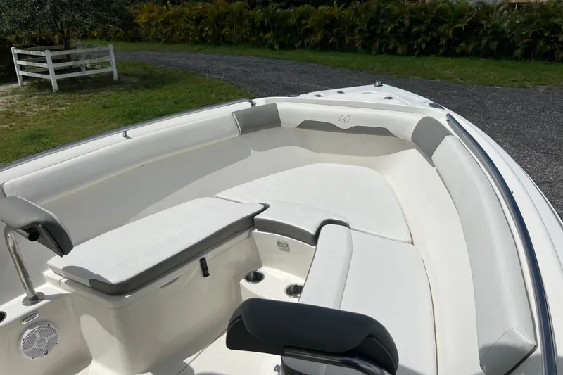 Slide: The Image of 2021 Sailfish 242 CC boat interior with cushioned seating and sleek design. - 9