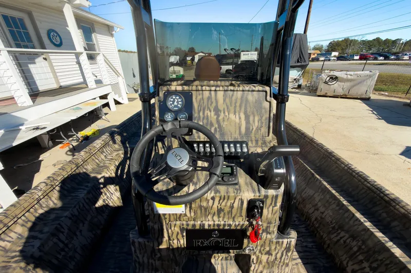 Slide: The Image of 2026 Excel 220 Bay Pro Elite boat interior with storage compartments and seating. - 12