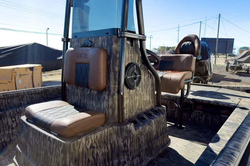 Slide: The Image of 2026 Excel 220 Bay Pro Elite boat with camo interior at a boat show. - 14
