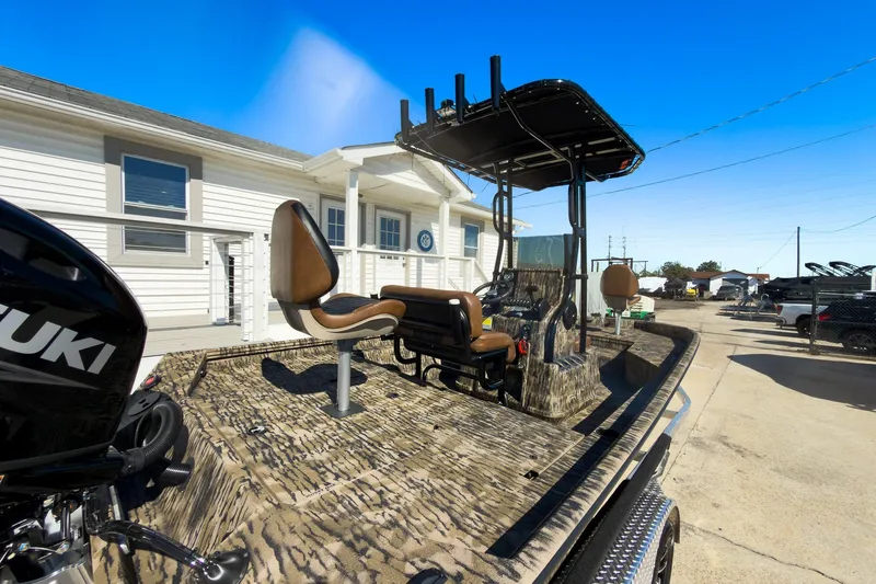 Slide: The Image of 2026 Excel 220 Bay Pro Elite boat interior with cushioned seating and camo design. - 8