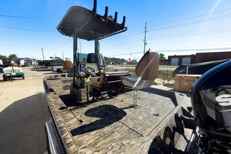 Slide: The Image of 2026 Excel 220 Bay Pro Elite boat interior with stylish seating and camo design. - 9