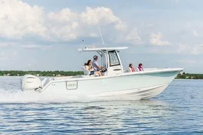 Slide: The Image of 2026 Sea Hunt Gamefish 27 Forward Seating boat cruising on a calm lake. - 1