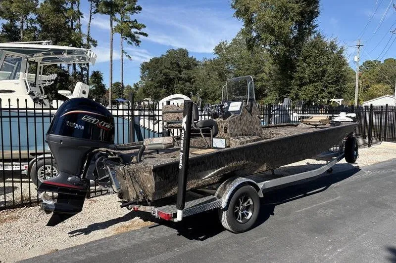Slide: The Image of 2026 Xpress H210B Bay boat on trailer with Yamaha outboard motor. - 2