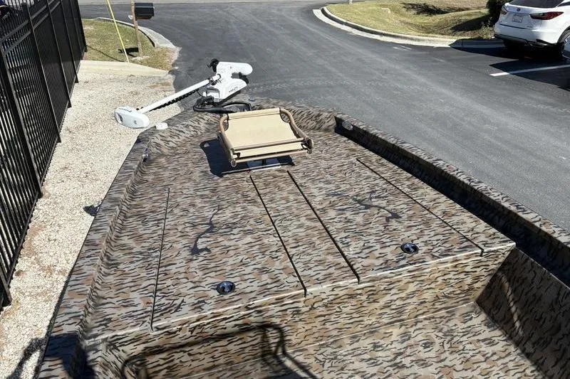 Slide: The Image of 2026 Xpress H210B Bay boat with camouflage design and trolling motor. - 4