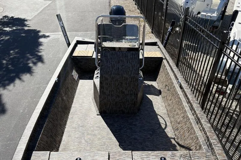 Slide: The Image of 2026 Xpress H210B Bay boat with camouflage design, parked outdoors. - 6