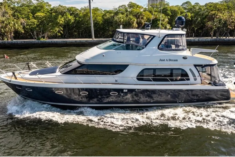 The Image of 2005 Carver 56 Voyager yacht cruising on a scenic waterway. - 0