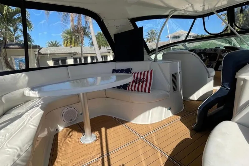 Slide: The Image of Interior of 2005 Carver 56 Voyager yacht with seating, table, and nautical decor. - 14