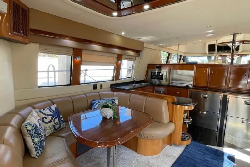 Slide: The Image of Luxurious interior of 2005 Carver 56 Voyager yacht with elegant dining area and modern kitchen. - 5