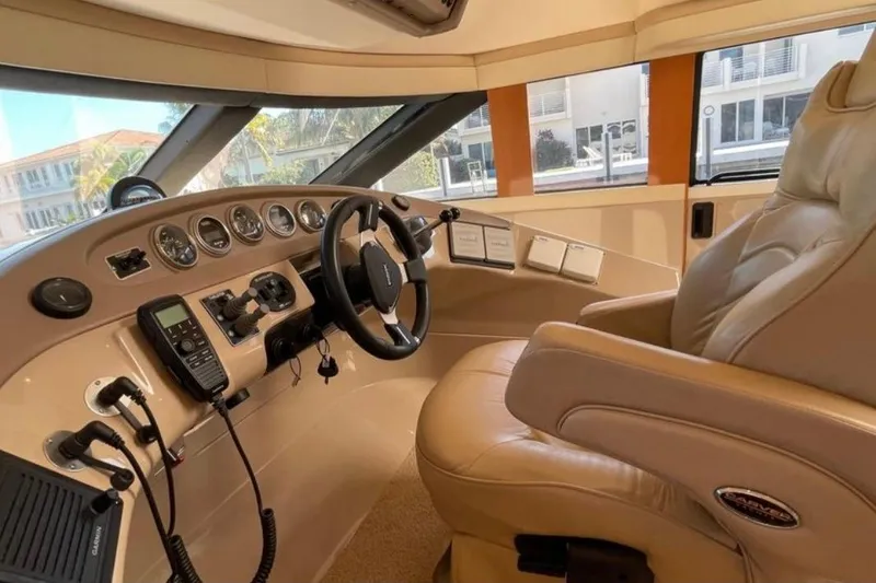 Slide: The Image of 2005 Carver 56 Voyager helm with leather captain's chair and advanced navigation controls. - 10