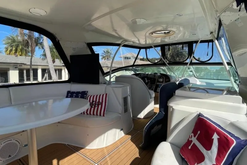 Slide: The Image of Interior of 2005 Carver 56 Voyager yacht with seating, table, and nautical decor. - 13